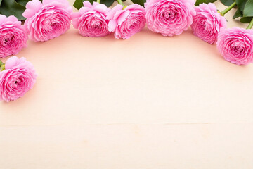 pink carnations on a wooden background