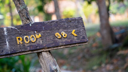 Rustic wooden sign pointing to room number 38