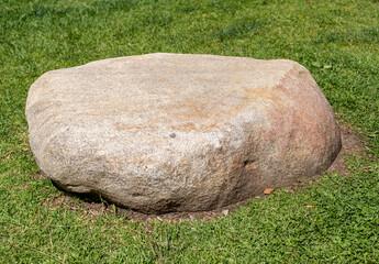large stone in the grass