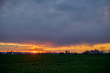 sunset over an agricultural field somewhere in the country