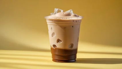 Takeaway iced mocha in a yellow background with a plastic cup