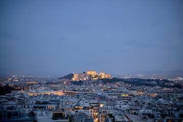 Aerial view of Athens at dusk with the Acropolis illuminated against the night sky. Greece