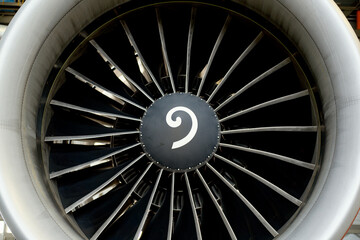 Close-up of a large aircraft engine turbine with visible fan blades.