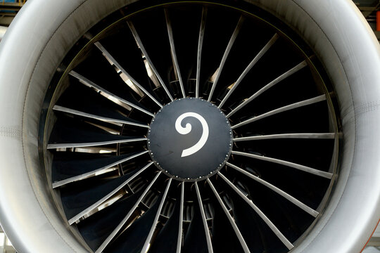 Close-up of a large aircraft engine turbine with visible fan blades.