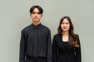 Portrait of young Asian couple wearing business uniform