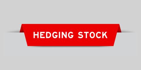 Red color inserted label with word hedging stock on gray background