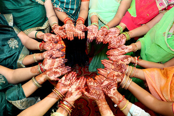 Group of Women Displaying Mehndi Designs in Traditional Indian Attire