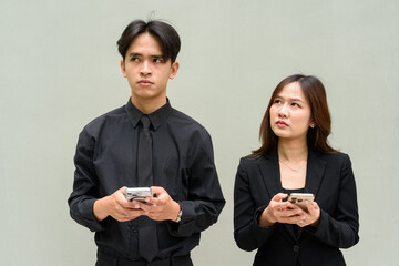 Portrait of young Asian couple wearing business uniform