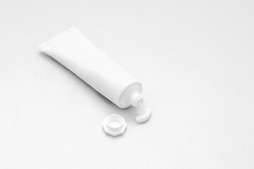 White tube of cream or ointment with cap on white background
