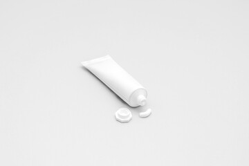 White tube of cream or ointment with cap on white background