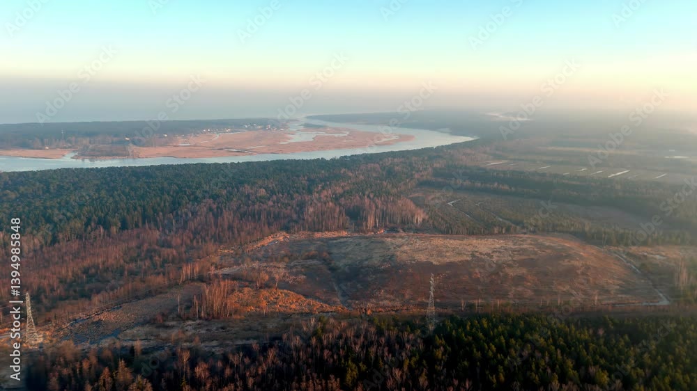 Poster aerial view of a vast forest meeting a winding river under golden evening light. the terrain transit