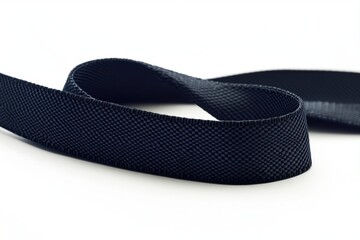 Black ribbon lying flat on a plain background for crafting and decoration purposes