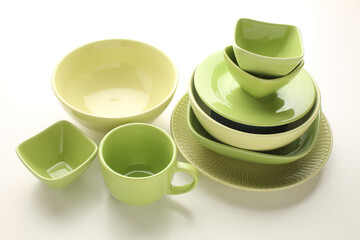 Beautiful multi-coloured bright ceramic bowl and tarenes, on a table top view