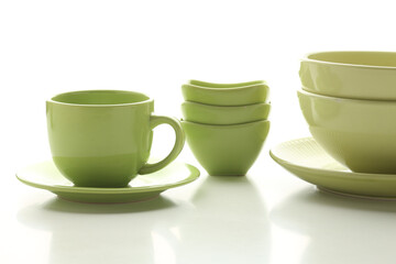 Beautiful multi-coloured bright ceramic bowl and tarenes on the table. Clean crockery concept