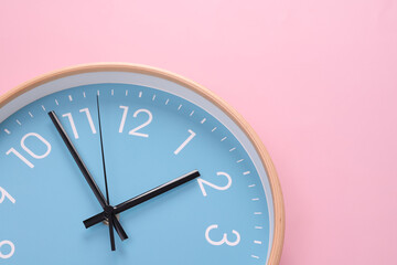 Close-up of a wall clock. The concept of time and work time is valuable for life, Alarm clock stopped. photo in a coloured background