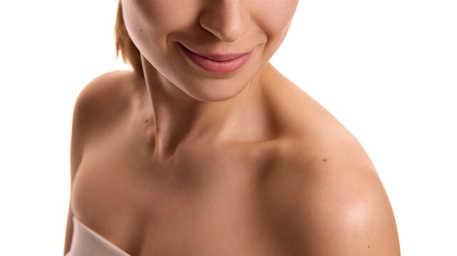 Cropped photo of young female body, neckline and shoulders with soft, smooth and toned body against white background. Collarbones. Concept of youth and natural beauty, cosmetology treatment, spa. Ad