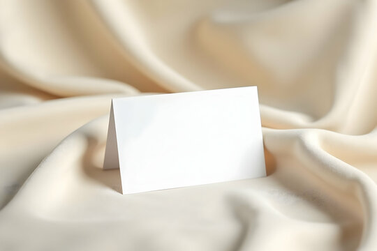 Elegant blank card resting on luxurious silk fabric, ideal for showcasing personalized messages, branding or invitation mockups with a touch of sophistication
