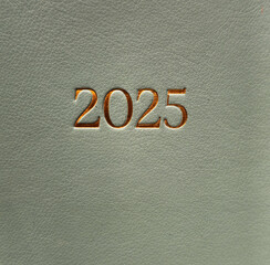 2025 on leather background. Diary, book.Background
