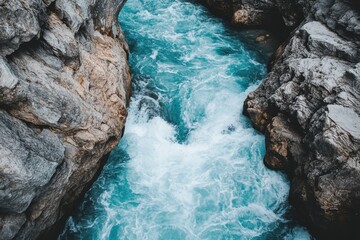 A river is flowing gently through a narrow canyon formed by two rocks