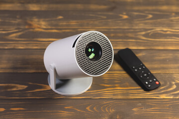 Modern Wi-Fi Projector and remote controle for video or photo presentation and home moovie watching.