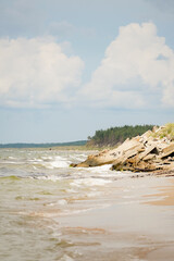 Old ruins blocking sandy beach till the water with forest sand dunes in the background coast line...