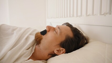 Man Sleeping on His Back with Black Mouth Tape in Bright White Bedroom, Nose Breathing and Anti...