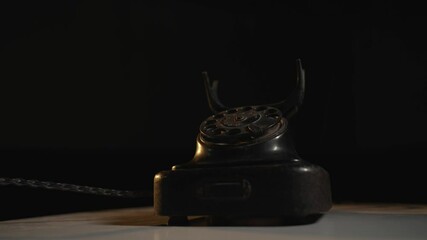 Close-up view of a lady waiting for a call from an old telephone. Girl answering to a call coming from a retro vintage rotary phone.