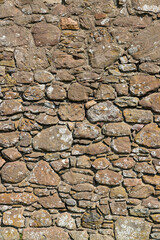 An ancient medieval brick wall tells stories of the past. Its worn textures and weathered details evoke legends and mysteries held within the stones over centuries