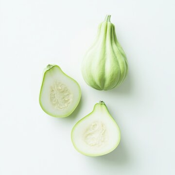 Arrangement of whole and sliced opo squash on a white surface on isoleted white  background