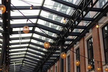 Garlands of lamps on the street. Light bulb decor, the string of lights on a urban background