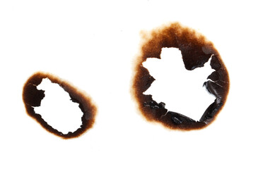 Two burned out holes in a piece of paper
