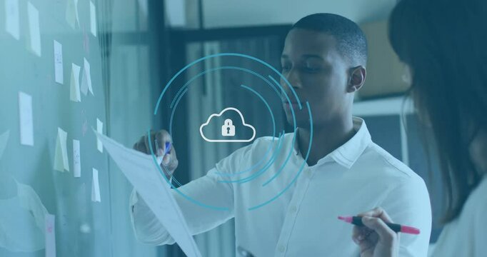 Discussing documents, business professionals with cloud security animation in office meeting - Powered by Adobe