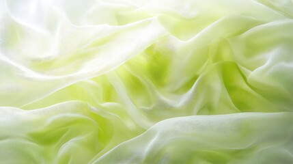Soft lime green silk fabric with delicate folds and translucent wavy flowing texture