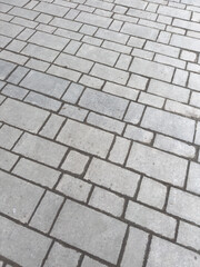A gray brick sidewalk with a gray brick pattern