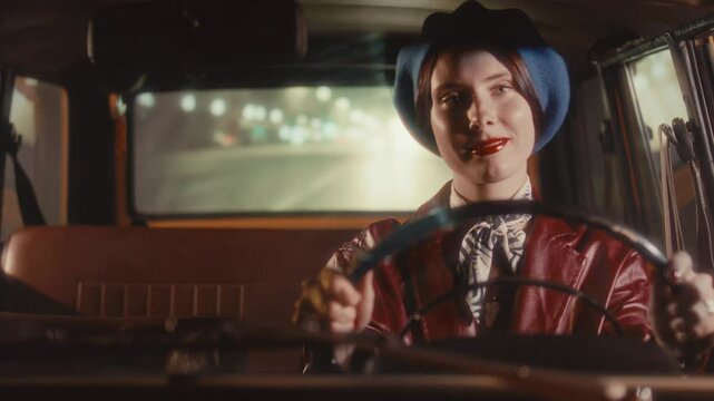 Cheerful woman in retro beret and red leather coat smiling and singing while driving vintage car at night, surrounded by glowing streetlights