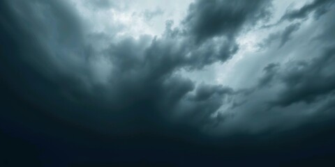 Obraz premium Dark Ominous Storm Clouds Gathering. A dramatic image of dark, heavy storm clouds filling the sky. The ominous atmosphere suggests an approaching thunderstorm or severe weather