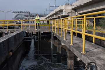 service engineer checking on waste water treatment plant with pump on background. worker working on Waste water plant.	
