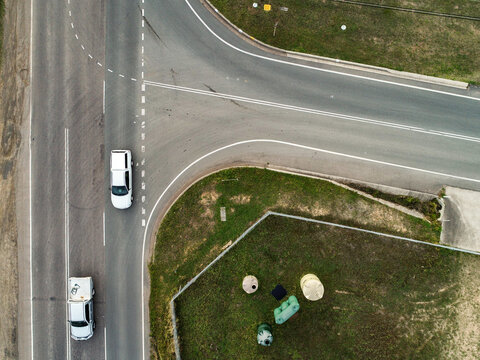 T-junction intersection of roads with cars driving along