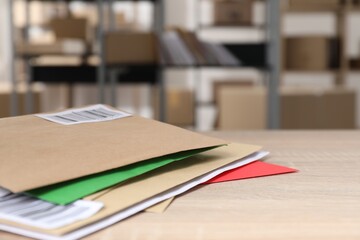 Many different envelopes on table in post office. Space for text