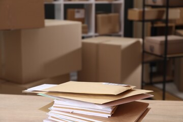 Many different envelopes on table in post office. Space for text