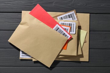 Different paper envelopes on grey wooden table, top view. Post office