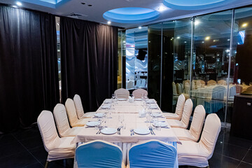 A beautifully set dining table awaits guests in a stylish venue with soft lighting