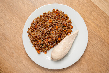 Savory bulgur with carrots complements a juicy chicken breast for a delicious dish