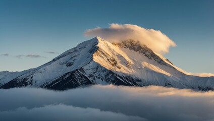Snowy Mountain Peak Illuminated by Sunrise with Clouds in a Serene Sky