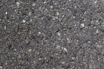 vista in primo piano di una superficie di asfalto vecchio e consumato, di colore grigio