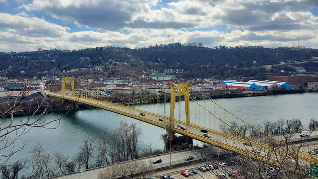 Pittsburgh, Pennsylvania, USA &ndash; March 18, 2024: The 10th Street Bridge spans the Monongahela River, connecting South Side to downtown under a partly cloudy sky.