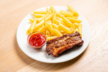 Tender ribs complement a serving of al dente pasta and a rich tomato sauce for a delightful meal