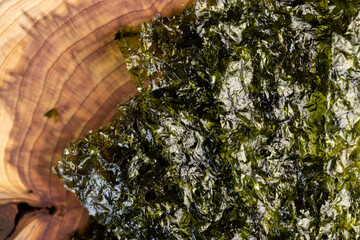 algae, natural green algae that are used to prepare Japanese dishes, Crumbs are scattered on the...