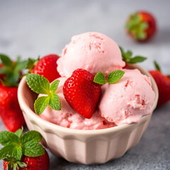 Delicious Pink Strawberry Ice Cream Scoops with Fresh Berries and Mint