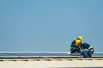 Two engineers install solar panels on a rooftop, wearing safety gear and helmets. The scene showcases renewable energy, green technology, and sustainable solutions under a clear blue sky.